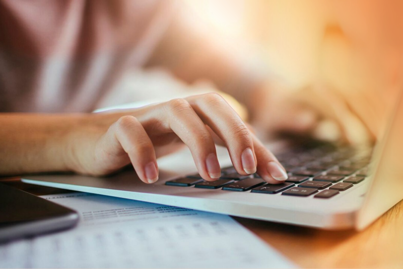 Woman Typing on Laptop