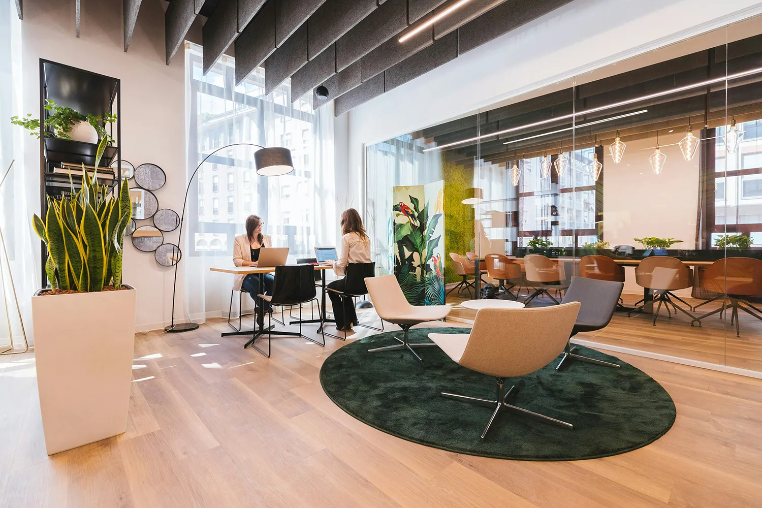 Modern Office Environment with Two Employees Using Communal Table